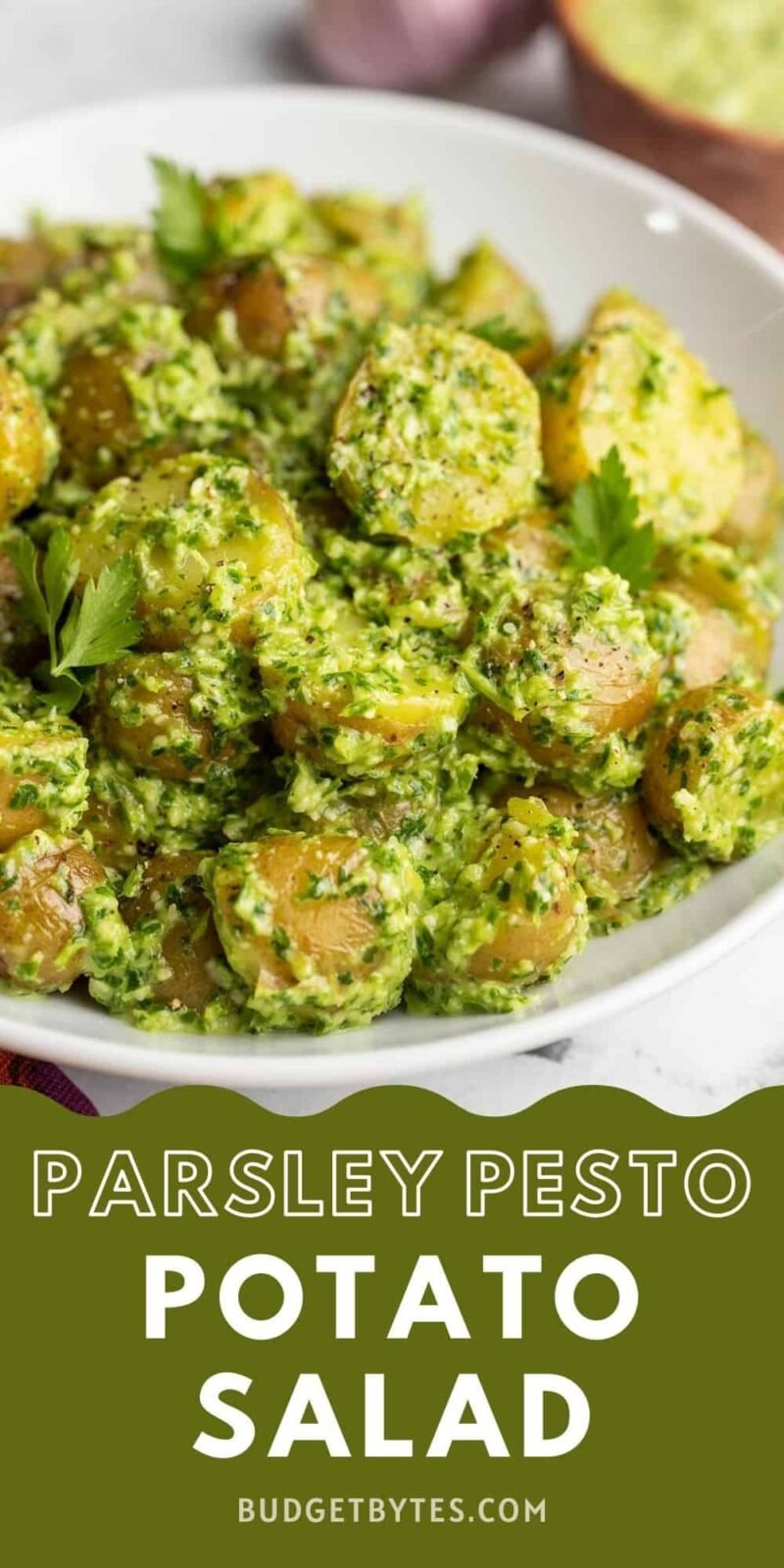Side view of a bowl of pesto potato salad, title text at the bottom.