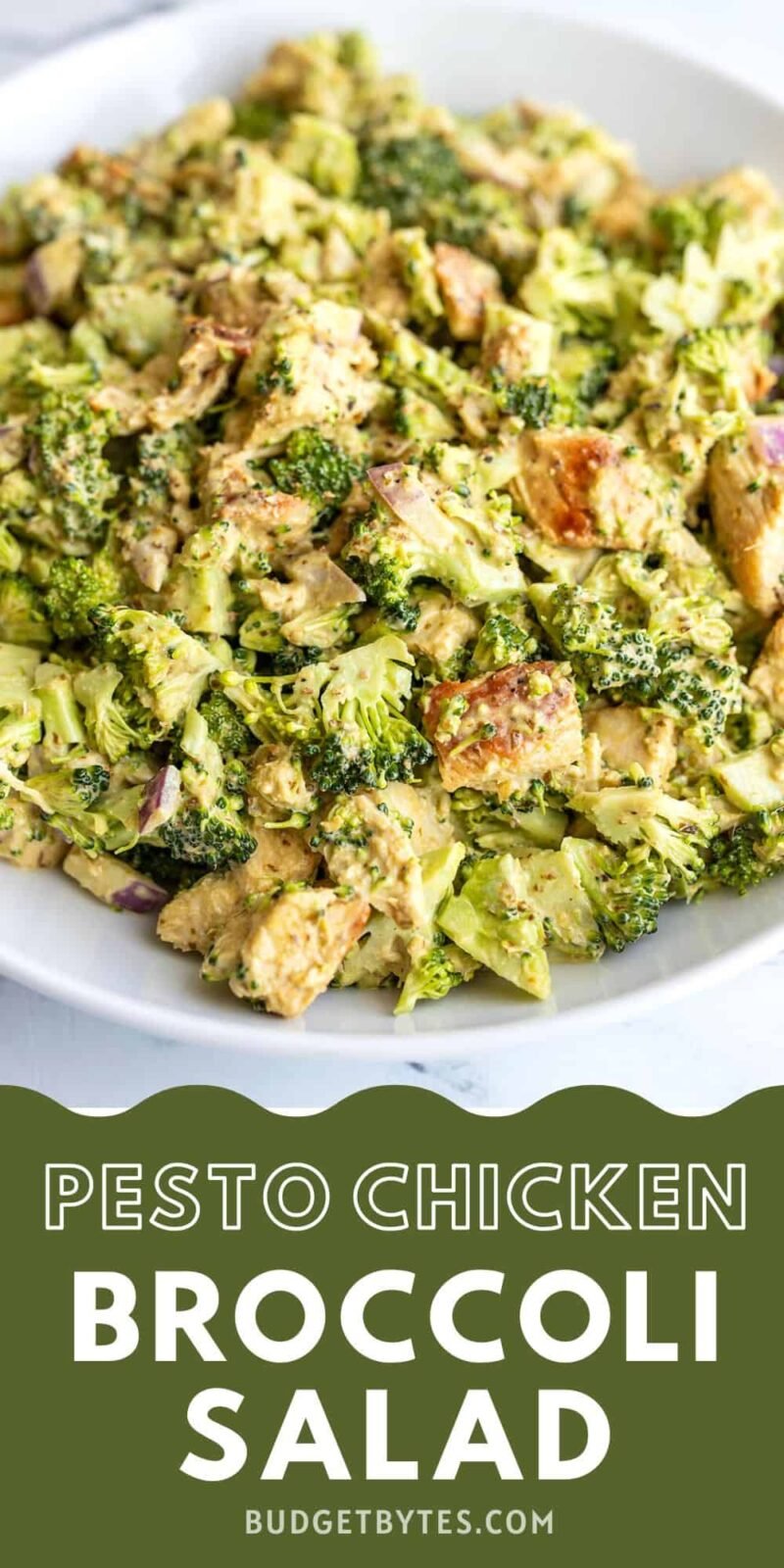 close up side view of a bowl of pesto chicken and broccoli salad.